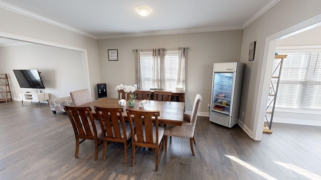 dining space featuring dark hardwood / wood-style flooring, crown molding, and wine cooler