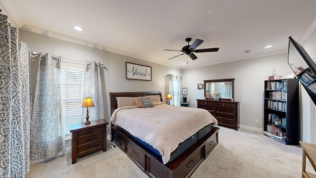 carpeted bedroom featuring ceiling fan and crown molding