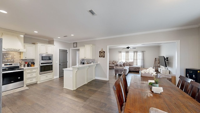 dining area featuring ceiling fan, dark hardwood / wood-style flooring, and ornamental molding