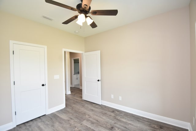5120 Judge Logue Rd, Newton, AL 36352 - unfurnished bedroom with wood finished floors and ceiling fan