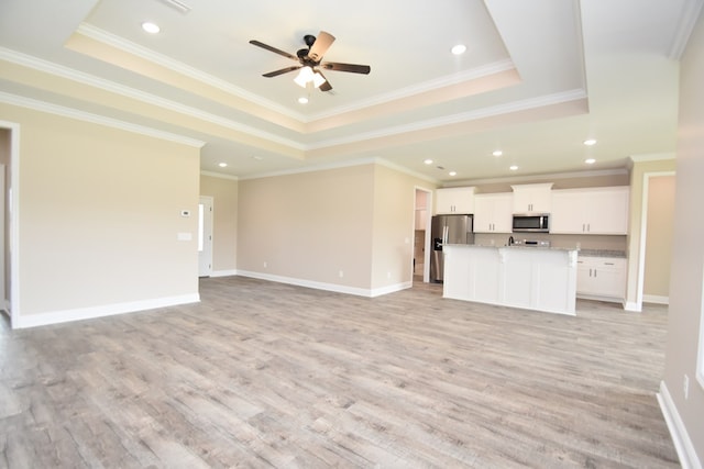 5120 Judge Logue Rd, Newton, AL 36352 - unfurnished living room with a raised ceiling, light wood-style flooring, ceiling fan, crown molding, and recessed lighting