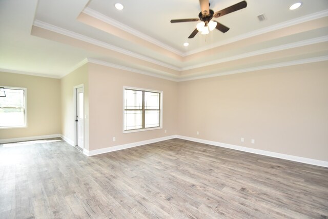 5120 Judge Logue Rd, Newton, AL 36352 - empty room featuring a raised ceiling, plenty of natural light, wood finished floors, ornamental molding, and recessed lighting