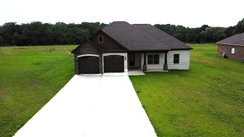 5120 Judge Logue Rd, Newton, AL 36352 - view of front facade with driveway, a garage, and a front yard