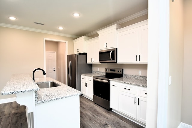 5120 Judge Logue Rd, Newton, AL 36352 - kitchen featuring appliances with stainless steel finishes, ornamental molding, dark wood-style floors, white cabinetry, and a kitchen island with sink
