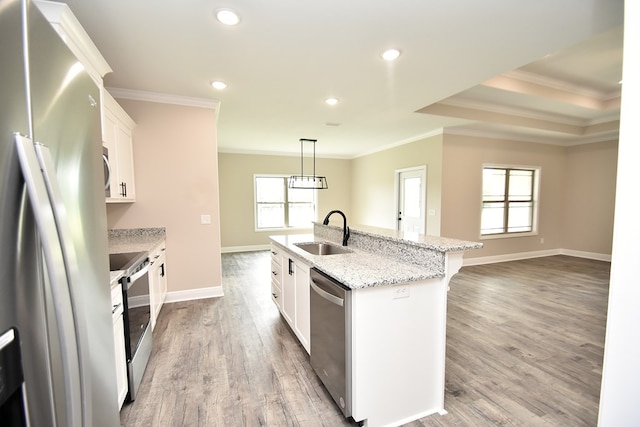 5120 Judge Logue Rd, Newton, AL 36352 - kitchen featuring stainless steel appliances, ornamental molding, an island with sink, light wood-type flooring, and white cabinets