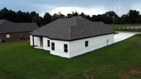 5120 Judge Logue Rd, Newton, AL 36352 - back of property with a lawn, a shingled roof, and a garage