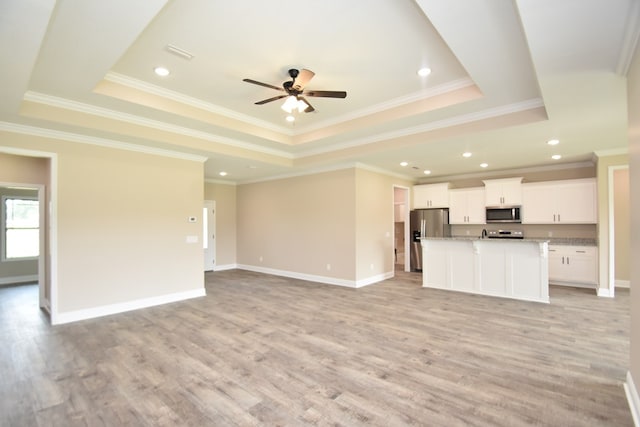 5120 Judge Logue Rd, Newton, AL 36352 - unfurnished living room with a raised ceiling, light wood finished floors, ceiling fan, ornamental molding, and recessed lighting