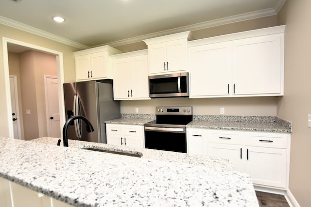 5120 Judge Logue Rd, Newton, AL 36352 - kitchen featuring stainless steel appliances, crown molding, white cabinets, recessed lighting, and light stone countertops
