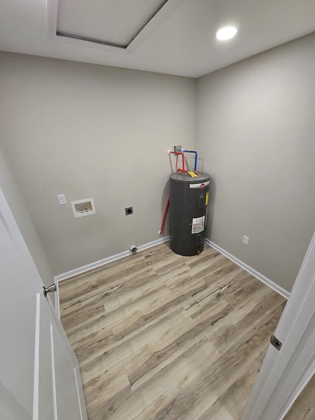 washroom with electric dryer hookup, water heater, washer hookup, and hardwood / wood-style flooring