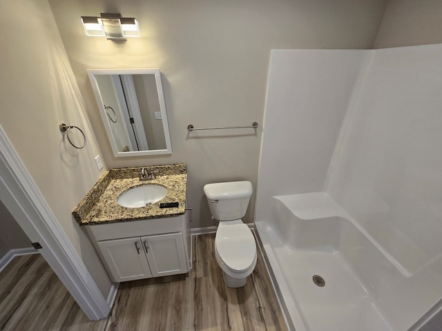 bathroom with vanity, toilet, and wood-type flooring