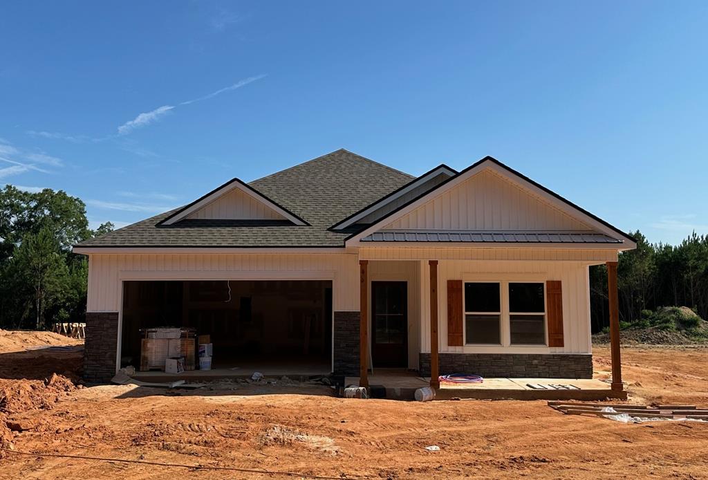 105 Jeter Dr, Midland City, AL 36350 - view of front facade with an attached garage, a shingled roof, and a standing seam roof