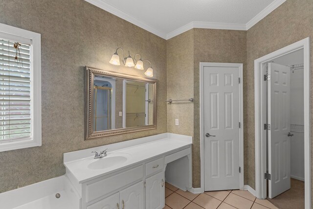 bathroom featuring tile patterned floors, crown molding, vanity, and a textured ceiling