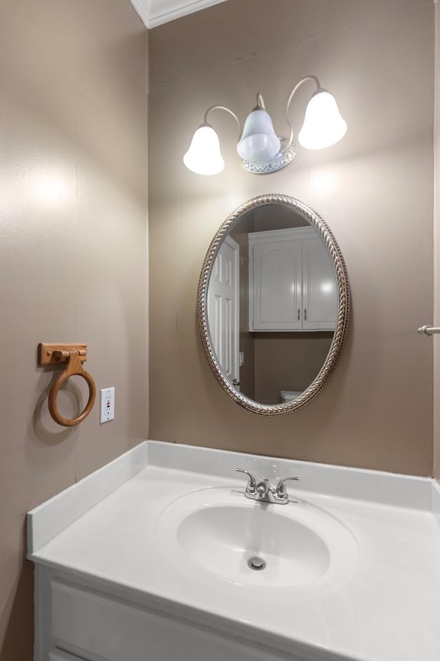 bathroom featuring crown molding and sink