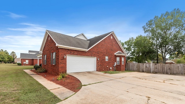 view of side of property with a lawn and a garage