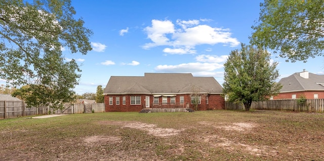 back of property with a lawn