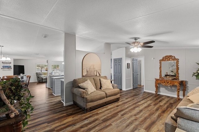 living room featuring a textured ceiling, dark hardwood / wood-style floors, vaulted ceiling, and ceiling fan