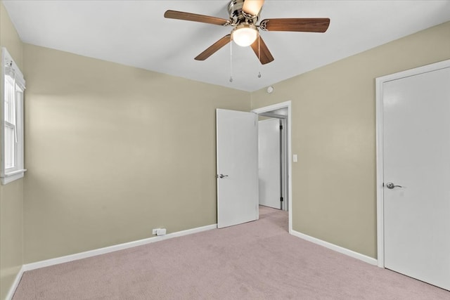 unfurnished bedroom featuring carpet floors, ceiling fan, and baseboards