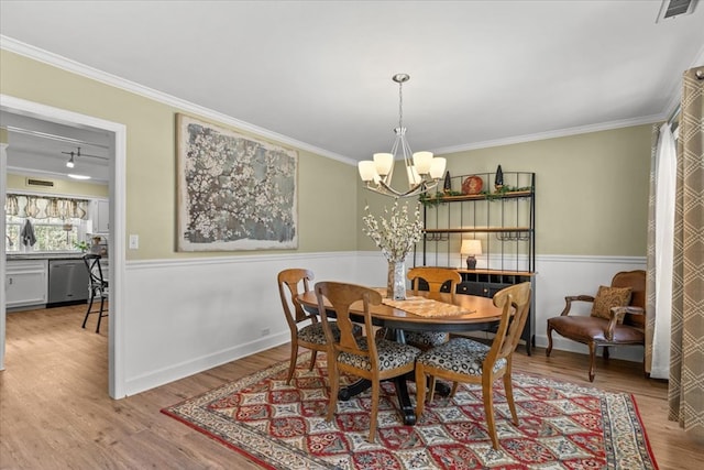 dining area with visible vents, crown molding, and wood finished floors