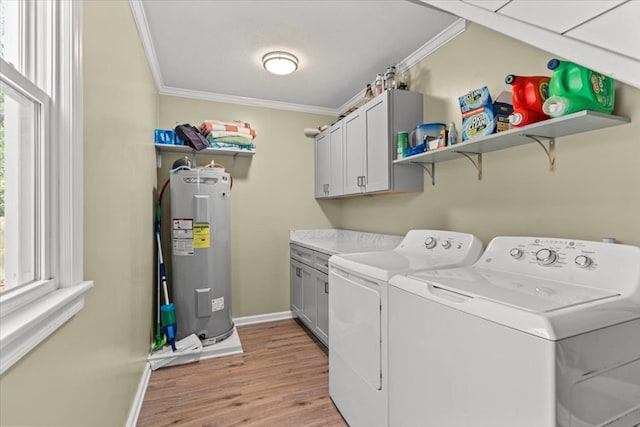 laundry area featuring crown molding, cabinet space, light wood-style flooring, electric water heater, and washer and dryer