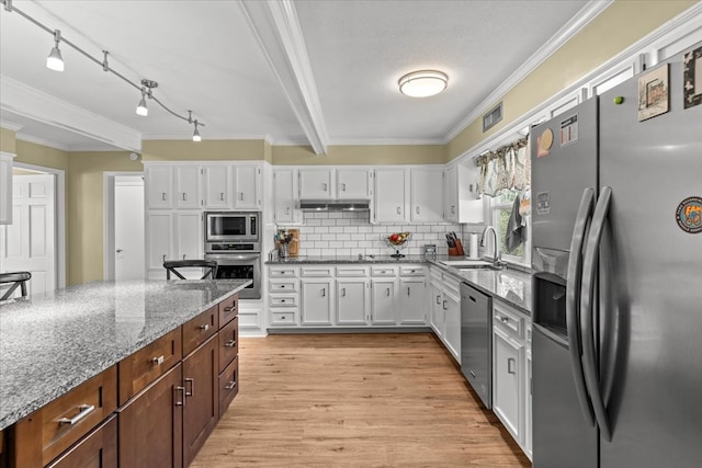 kitchen featuring stainless steel appliances, a sink, visible vents, and white cabinetry