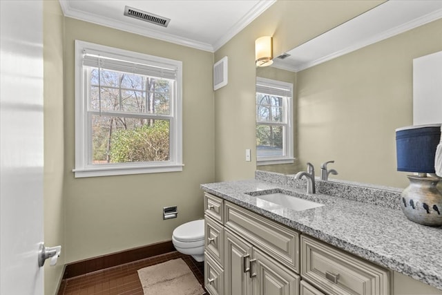 bathroom with crown molding, visible vents, toilet, vanity, and baseboards