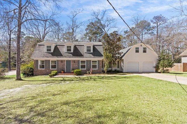 view of front of home with brick siding, concrete driveway, fence, a garage, and a front lawn