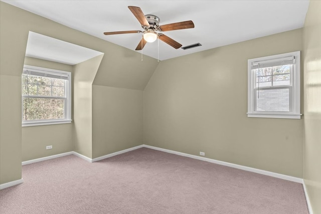 bonus room with lofted ceiling, visible vents, a ceiling fan, carpet flooring, and baseboards