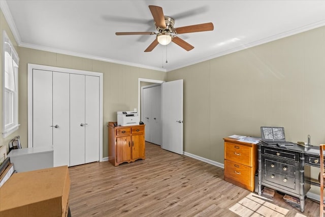 home office featuring light wood-style floors, baseboards, ornamental molding, and a ceiling fan