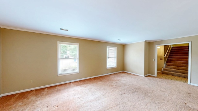 empty room featuring carpet flooring, baseboards, and ornamental molding