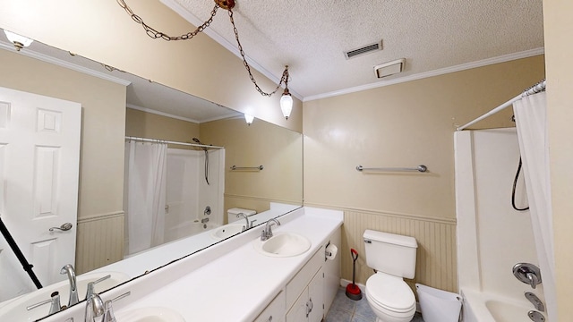 bathroom with visible vents, shower / tub combo with curtain, wainscoting, a textured ceiling, and a sink