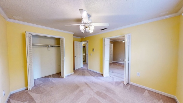 unfurnished bedroom featuring visible vents, carpet flooring, a closet, and ornamental molding