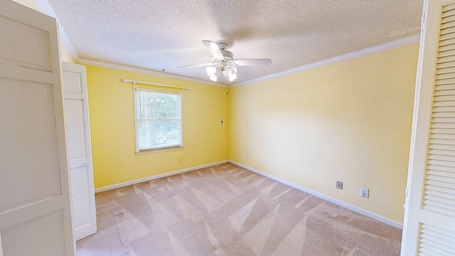 unfurnished bedroom with baseboards, ornamental molding, a textured ceiling, and light colored carpet