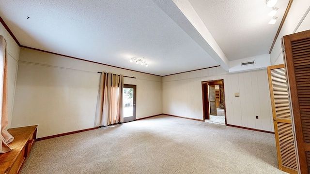 interior space featuring visible vents, a textured ceiling, baseboards, and light carpet