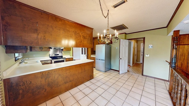 kitchen featuring a textured ceiling, stainless steel electric range oven, a sink, light countertops, and freestanding refrigerator