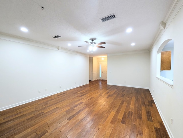 spare room featuring ceiling fan, ornamental molding, hardwood / wood-style flooring, and visible vents