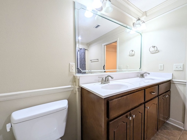 bathroom with toilet, visible vents, ornamental molding, and a sink