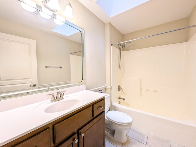 bathroom featuring a skylight, shower / bath combination, toilet, vanity, and tile patterned flooring