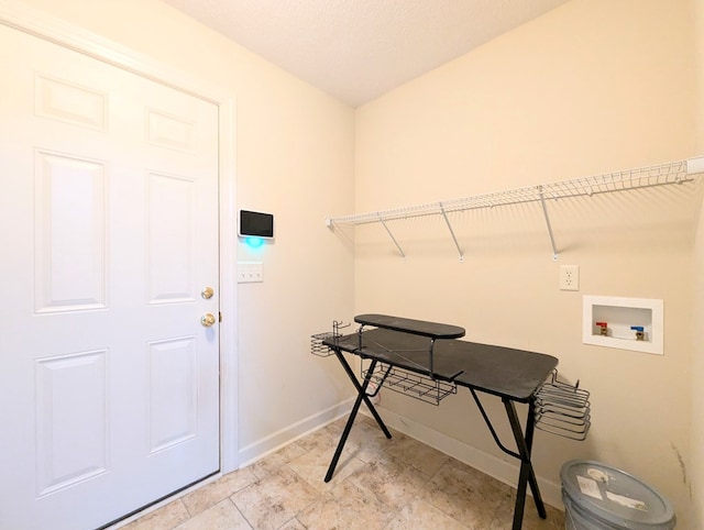 clothes washing area with laundry area, washer hookup, and baseboards