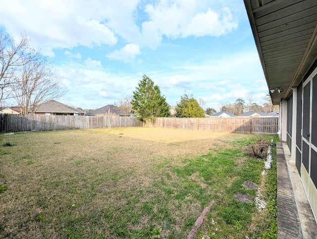 view of yard with a fenced backyard