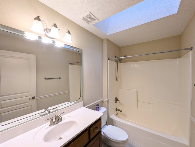 bathroom with a skylight, visible vents, toilet, a textured ceiling, and vanity