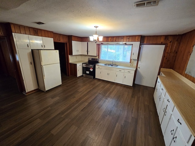 kitchen featuring stainless steel range, sink, decorative light fixtures, white cabinets, and white fridge