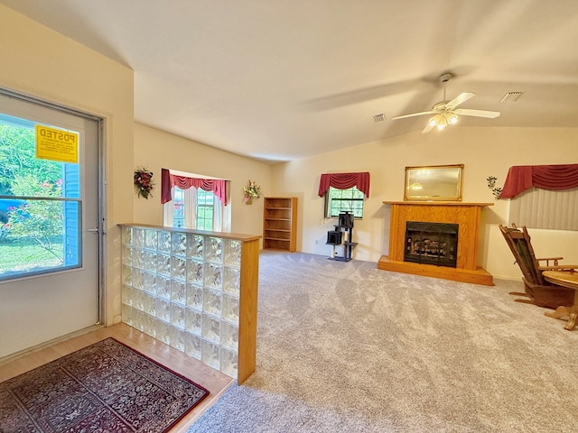 4955 County Road 36, Hartford, AL 36344 - carpeted living room featuring ceiling fan, lofted ceiling, and a fireplace with raised hearth