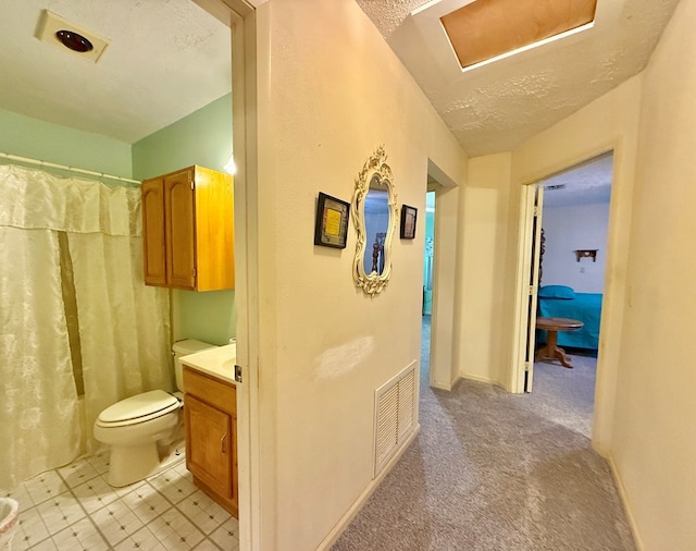 4955 County Road 36, Hartford, AL 36344 - full bathroom with toilet, vanity, a shower with shower curtain, and a textured ceiling