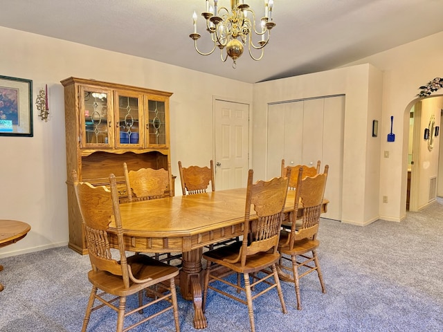 4955 County Road 36, Hartford, AL 36344 - dining area with arched walkways, light colored carpet, a chandelier, and baseboards