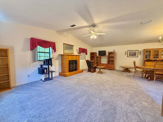 4955 County Road 36, Hartford, AL 36344 - carpeted living room featuring a ceiling fan, lofted ceiling, a fireplace with raised hearth, and baseboards