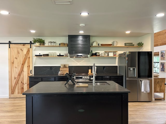489 Skipper Rd, Malvern, AL 36375 - kitchen featuring open shelves, a sink, stainless steel fridge with ice dispenser, light wood-style floors, and a kitchen island with sink