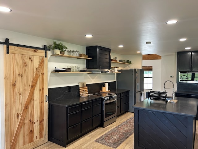 489 Skipper Rd, Malvern, AL 36375 - kitchen featuring light wood-style floors, dark countertops, open shelves, and appliances with stainless steel finishes