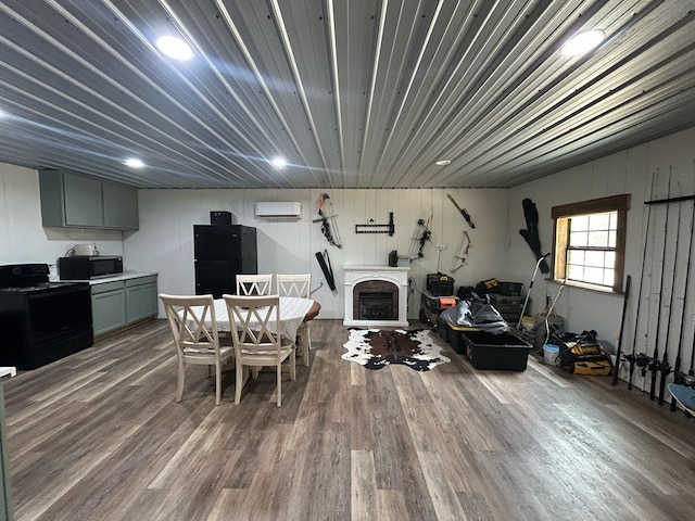 489 Skipper Rd, Malvern, AL 36375 - dining room featuring an AC wall unit, wood finished floors, and a fireplace