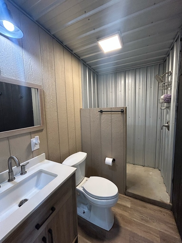 489 Skipper Rd, Malvern, AL 36375 - full bath with vanity, a stall shower, toilet, and wood finished floors