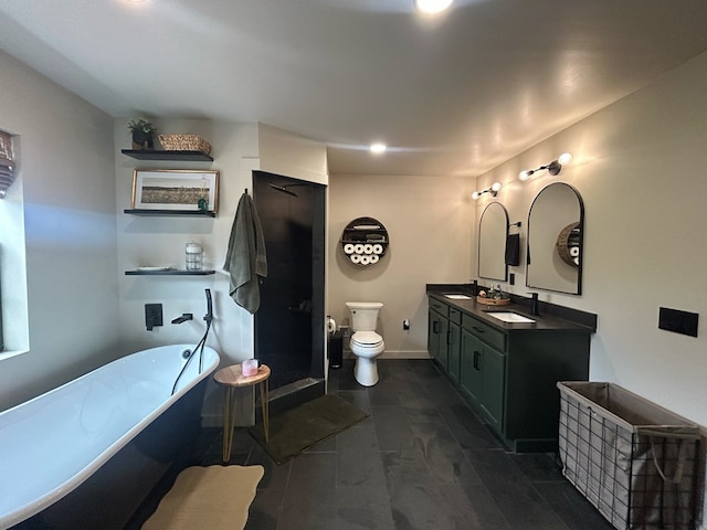 489 Skipper Rd, Malvern, AL 36375 - full bathroom with double vanity, toilet, a soaking tub, a shower stall, and a sink